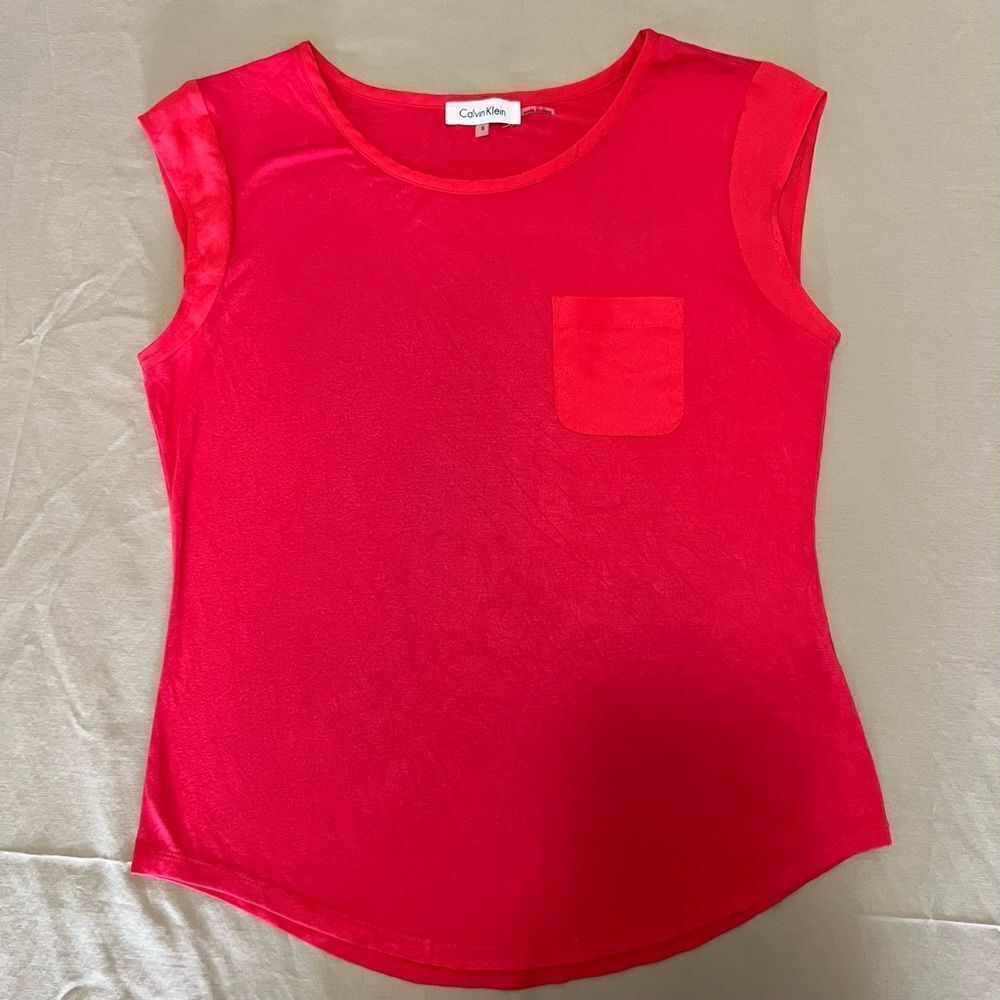 Calvin Klein shirt in a orange peach color in a size small